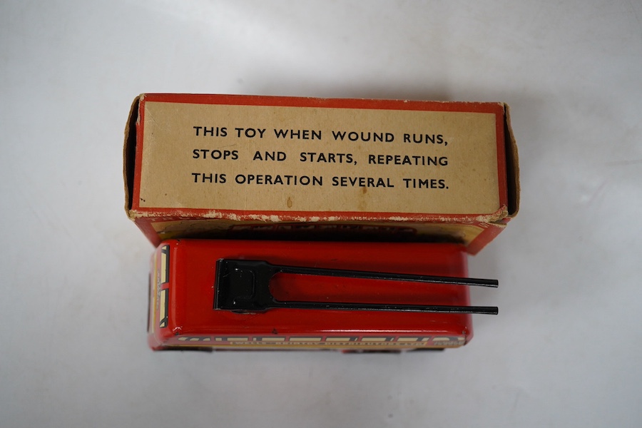 A boxed Wells Brimtoy tinplate clockwork trolley bus loosely in London Transport livery, together with three keys. Condition fair to good, clockwork motor appears to work correctly although has lost grip on the driving a